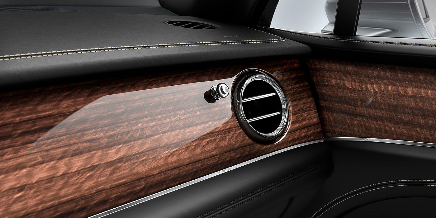 Bentley Chongqing Bentley Bentayga front interior Crown Cut Walnut veneer and chrome air vent.